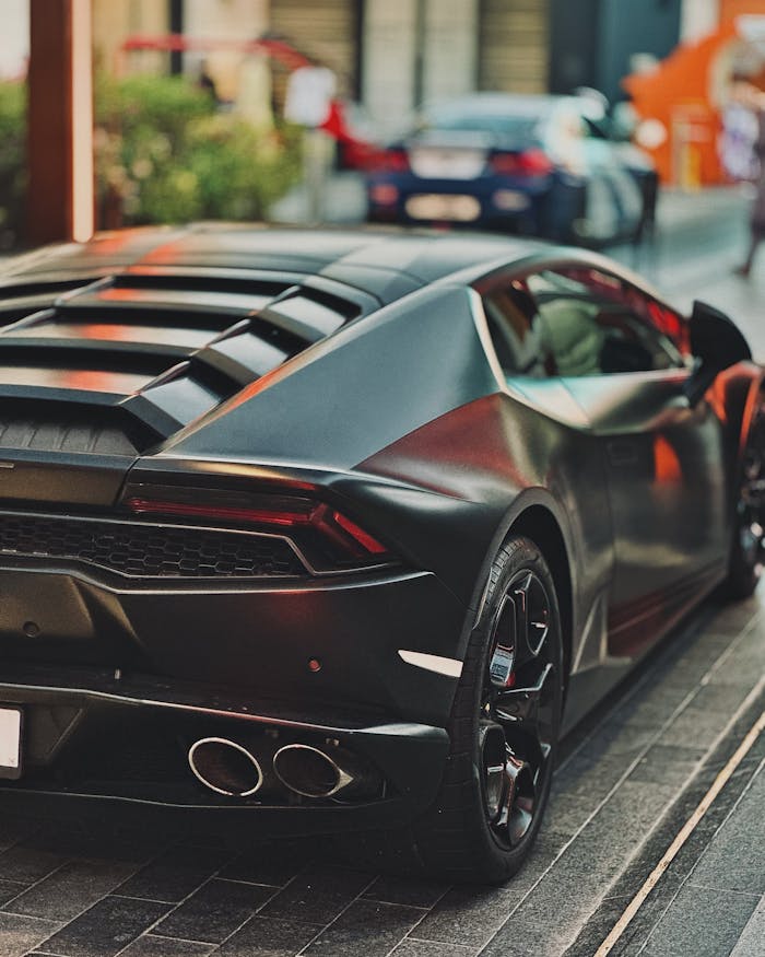 contact-img Sleek luxury sports car parked in vibrant Dubai street, showcasing modern design and elegance.