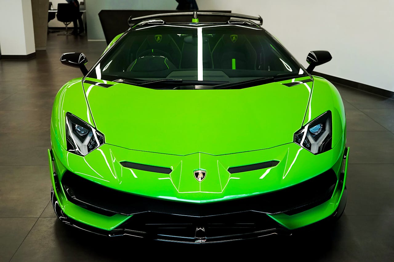 Sleek luminous green Lamborghini showcased in an elegant indoor showroom, epitomizing luxury and speed.